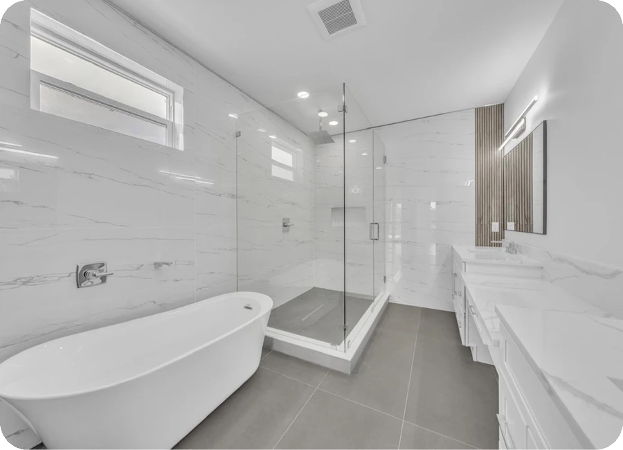 Custom master bathroom with freestanding tub, marble tile surround, and frameless glass shower — Tampa, FL