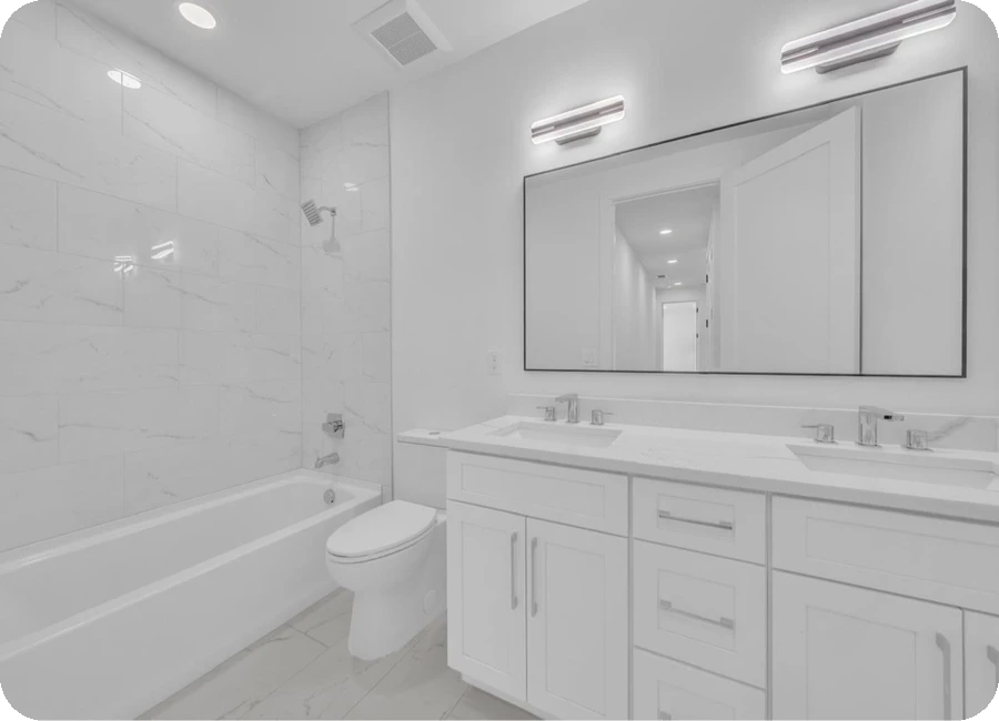Secondary bathroom with marble tile tub surround and double vanity — Hillsborough County