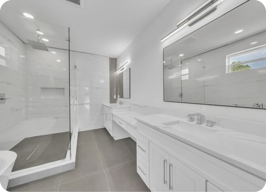 Large format marble tile shower with double vanity and recessed niche — Tampa Bay area